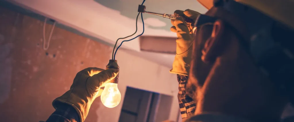 Man replacing a light bulb