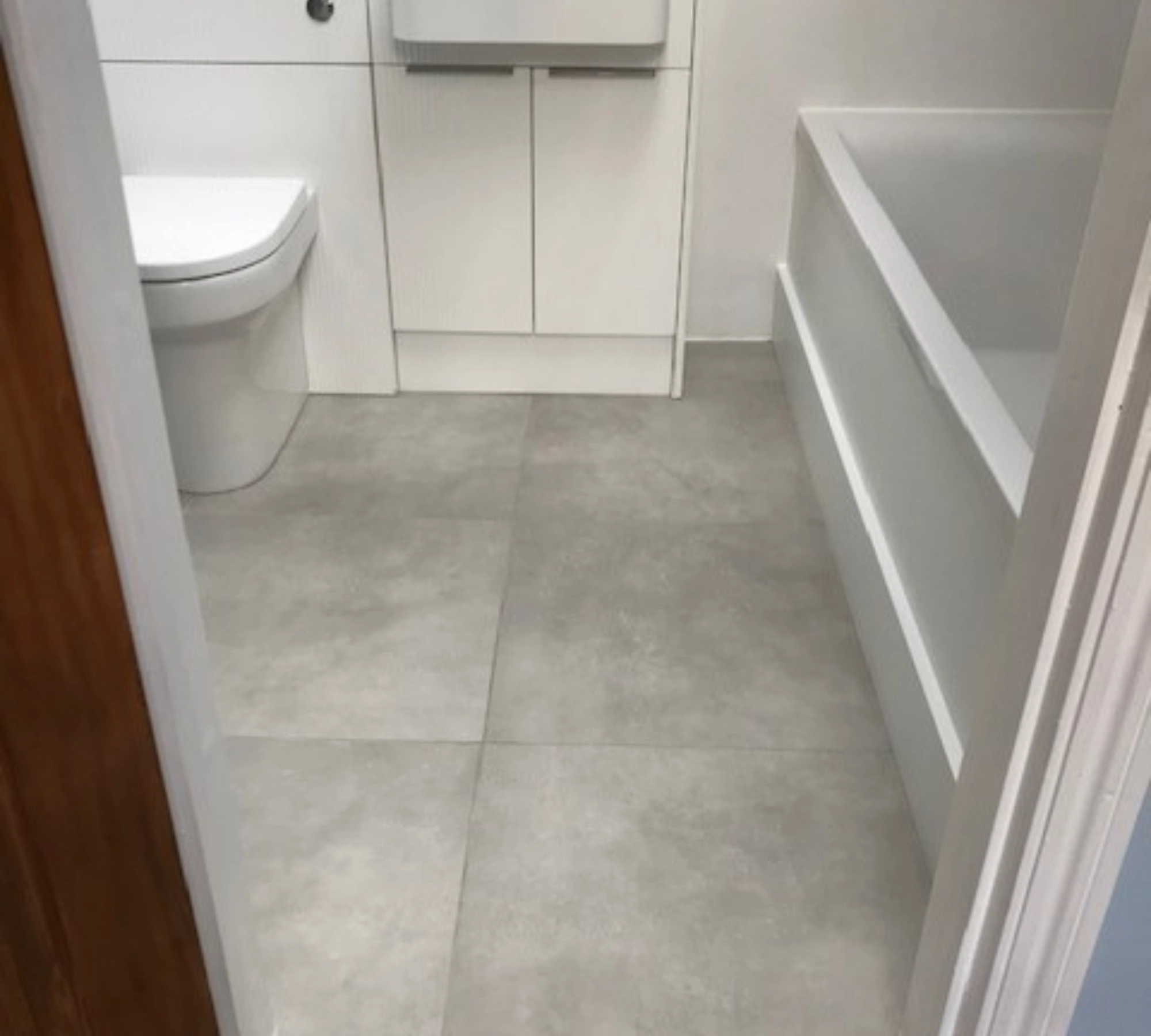 Grey tiled bathroom floor