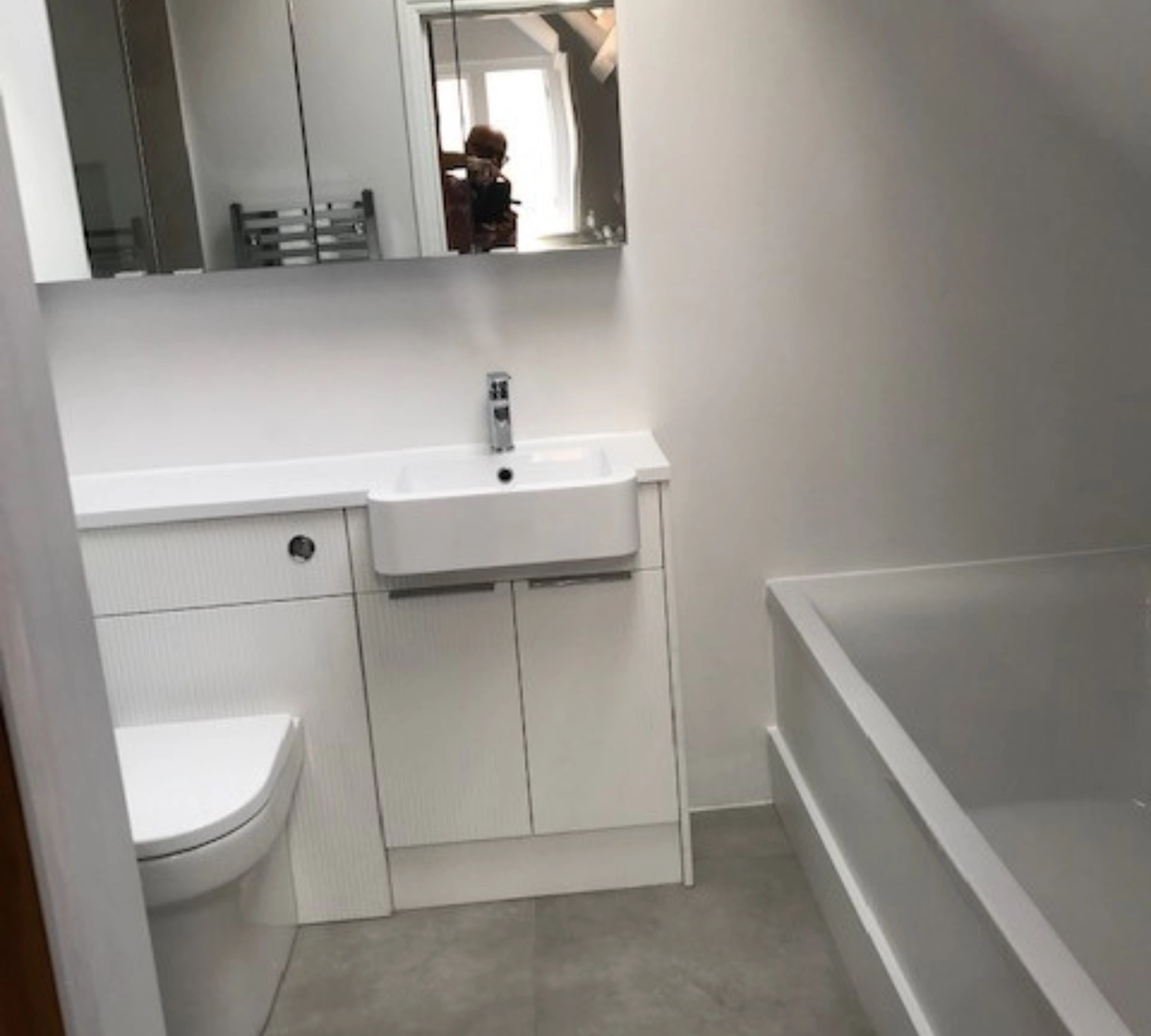 White bathroom with sink and tub