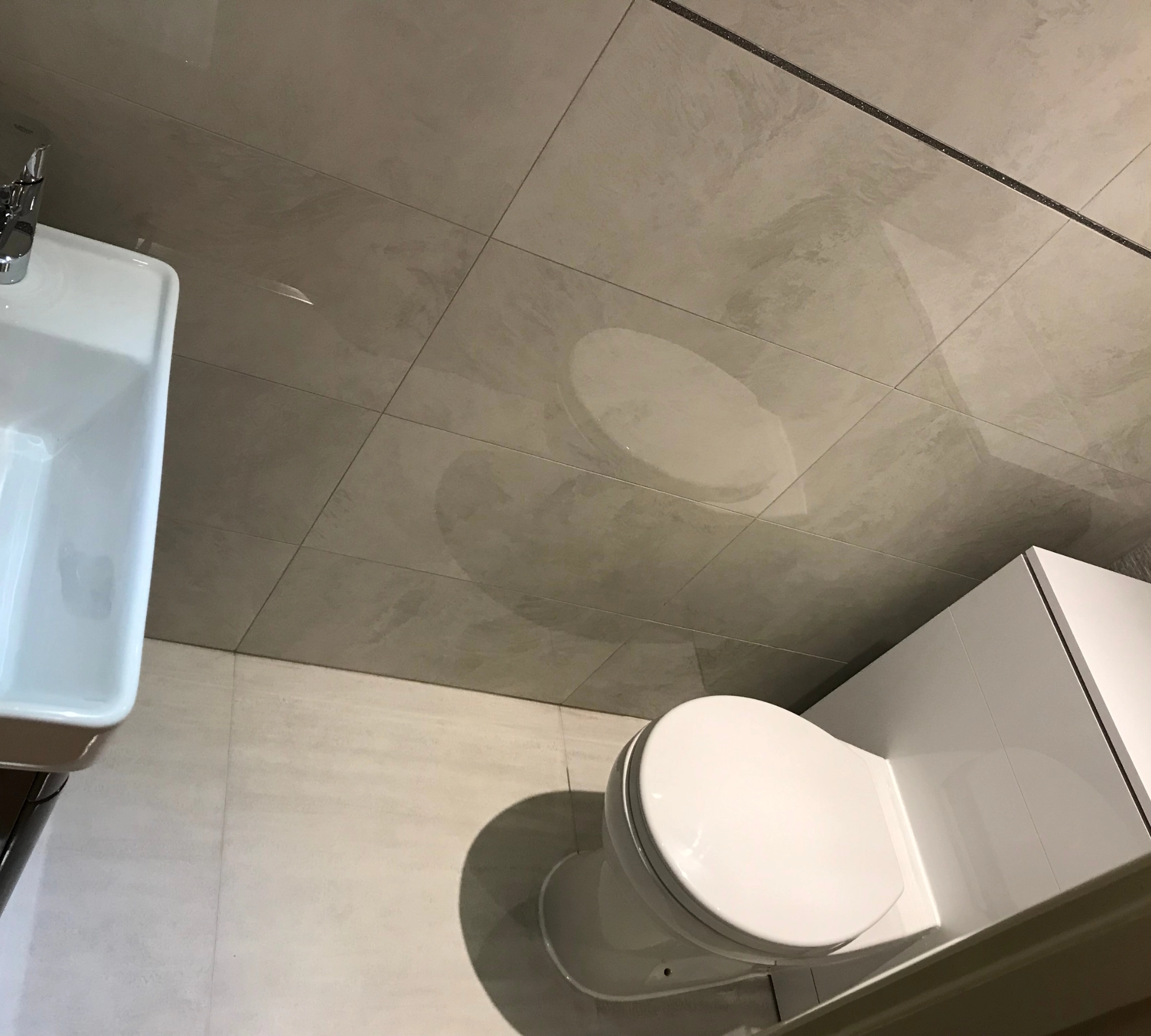 Tiled bathroom floor with toilet