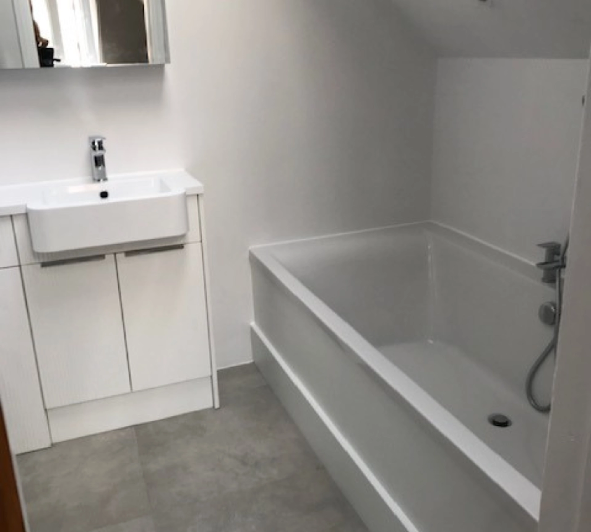 White bathroom with sink and tub